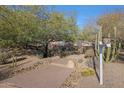 Landscaped walkway leads to a charming home entrance at 6486 E Oberlin Way, Scottsdale, AZ 85266