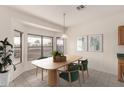 Cozy dining area with a modern table and chairs near large windows at 1211 E Torrey Pines Ln, Chandler, AZ 85249