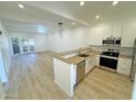 Modern kitchen with stainless steel appliances and light wood flooring at 1217 N Miller Rd # 8, Scottsdale, AZ 85257