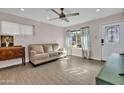 Living room with light beige couch and wood-look floors at 4830 E Palm Ln, Phoenix, AZ 85008