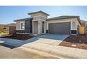 Modern single story home with gray exterior and a two car garage at 20105 W Campbell Ave, Buckeye, AZ 85396