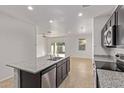 Open-concept kitchen showcasing stainless steel appliances, granite countertops, and ample natural light at 36375 W Picasso St, Maricopa, AZ 85138