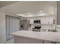 Modern kitchen with stainless steel appliances and white cabinets at 3753 S Mill Ave, Tempe, AZ 85282