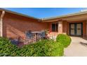 Small patio with wrought iron furniture and lush landscaping at 5022 E Magic Stone Dr, Phoenix, AZ 85044