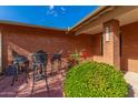 Small patio with wrought iron furniture near the front entrance at 5022 E Magic Stone Dr, Phoenix, AZ 85044