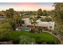 Aerial view of a beautiful home with a large backyard, pool, and spa at 6501 E Cholla St, Scottsdale, AZ 85254