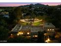 Night time aerial view of a gorgeous home with a large backyard and city views at 6501 E Cholla St, Scottsdale, AZ 85254