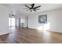 Bright living room with hardwood floors and ceiling fan at 6842 W Holly St, Phoenix, AZ 85035