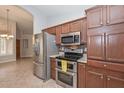 Traditional kitchen features stainless appliances, granite counters, and tile backsplash at 8390 W Oraibi Dr, Peoria, AZ 85382