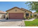 House exterior featuring a brown garage door and neat landscaping at 16209 W Davis Rd, Surprise, AZ 85374