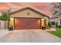 Attractive home showcasing a brown garage door and well-kept lawn at 16209 W Davis Rd, Surprise, AZ 85374