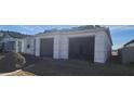 New home exterior featuring a large two car garage with an unfinished yard and visible roof details at 2671 E Abe Truckle Ave, San Tan Valley, AZ 85140