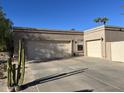 Two-car garage with ample parking space and desert landscaping at 3824 E Kachina Dr, Phoenix, AZ 85044