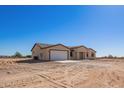 Brand new single-story home showcasing desert landscaping and a modern design at 6300 N 419Th Ave, Tonopah, AZ 85354