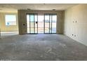 Spacious living room featuring sliding glass doors and a large window offering abundant natural light at 7631 W Tether Trl, Peoria, AZ 85383