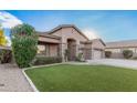 One-story home with a well-maintained front yard at 1239 E Kramer Cir, Mesa, AZ 85203