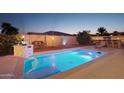 Inviting backyard pool with built-in spa and outdoor kitchen at 12866 S 183Rd Ave, Goodyear, AZ 85338