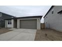 A single story home with a two car garage and desert landscaping at 32181 N Saddlehorn Dr, San Tan Valley, AZ 85140