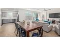 Open concept dining area with a rustic wooden table and metal chairs at 2955 N Augustine --, Mesa, AZ 85207