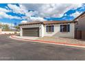 Attached garage with brown door and stone driveway at 2955 N Augustine --, Mesa, AZ 85207