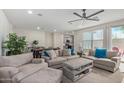 Spacious living room with beige sofas, a large TV, and a coffee table at 2955 N Augustine --, Mesa, AZ 85207