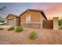 Side view of a single-story home with gray garage door at 4969 W Beckham Way, San Tan Valley, AZ 85144