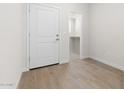 Hallway view showing the flooring and access to a walk-in closet at 7450 S 75Th Dr, Laveen, AZ 85339