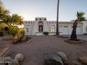 Stylish southwestern home featuring a unique arched entryway, white stucco, and desert landscaping at 14211 N Fountain Hills Blvd # B, Fountain Hills, AZ 85268