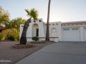 Southwestern home with a well-maintained exterior and low-maintenance desert landscaping featuring palm trees at 14211 N Fountain Hills Blvd # B, Fountain Hills, AZ 85268