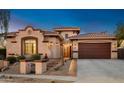 Beautiful Spanish-style home with a two-car garage and mature landscaping at 1840 W Sierra Sunset Trl, Phoenix, AZ 85085