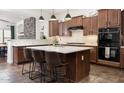Beautiful kitchen features large island with seating, stone accent wall, and stainless steel appliances at 1840 W Sierra Sunset Trl, Phoenix, AZ 85085