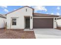 Inviting facade of a modern residence featuring a stucco exterior, dark brown garage door, and drought-tolerant landscaping at 23411 W Albeniz Pl, Buckeye, AZ 85326