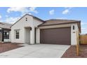 Attractive single Gathering home with a two-car garage, stucco exterior, and desert landscaping at 23411 W Albeniz Pl, Buckeye, AZ 85326
