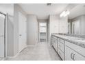 Bathroom with granite counters, double sinks, and walk-in shower; neutral color palette and spacious layout at 8975 S 168Th Ln, Goodyear, AZ 85338
