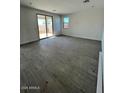 Open-concept living room with tile flooring and sliding glass doors at 23327 W Florence Ave, Buckeye, AZ 85326