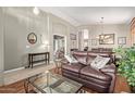 Spacious living room with hardwood floors and leather furniture at 5827 W Charter Oak Rd, Glendale, AZ 85304