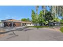 Property features a large driveway, attached garage, and lush landscaping at 6319 E Mariposa St, Scottsdale, AZ 85251