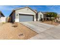 House exterior showcasing a gray two-car garage and landscaping at 7834 W Forest Grove Ave, Phoenix, AZ 85043