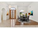 Elegant dining room featuring hardwood floors and a stunning chandelier at 13026 W Foxfire Dr, Sun City West, AZ 85375