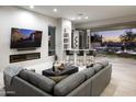 Living room with fireplace, bar, and sliding doors to backyard at 14146 N 106Th Way, Scottsdale, AZ 85255