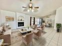 Bright living room features a fireplace and opens to dining area at 18024 N 36Th Ln, Glendale, AZ 85308