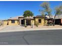 Charming single-story home featuring desert landscaping, a stone facade, and a private front entrance at 18174 W Wind Song Ave, Goodyear, AZ 85338