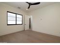 Bright bedroom featuring hardwood floors, a ceiling fan, and a walk-in closet at 23002 N Country Club Trl Trl, Scottsdale, AZ 85255