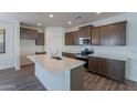 Modern kitchen with island, stainless steel appliances, and ample cabinetry at 24144 W Gibson Ln, Buckeye, AZ 85326