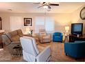 Bright living room featuring comfortable seating, including recliners, and a ceiling fan at 7829 E Naranja Ave, Mesa, AZ 85209