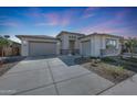 Single story home with two-car garage and desert landscaping at 13487 W Roy Rogers Rd, Peoria, AZ 85383