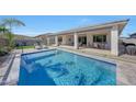 Relaxing pool area with a covered patio and seating at 13487 W Roy Rogers Rd, Peoria, AZ 85383