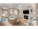 Spacious living room featuring a fireplace and built-in shelving at 16502 W Arroyo Ct, Surprise, AZ 85374