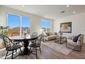 Bright dining area with round table and chairs, adjacent to living room at 18116 W Cielo Grande Ave, Surprise, AZ 85387