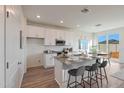 Eat-in kitchen featuring white cabinets, granite island, and sliding door access to backyard at 18116 W Cielo Grande Ave, Surprise, AZ 85387